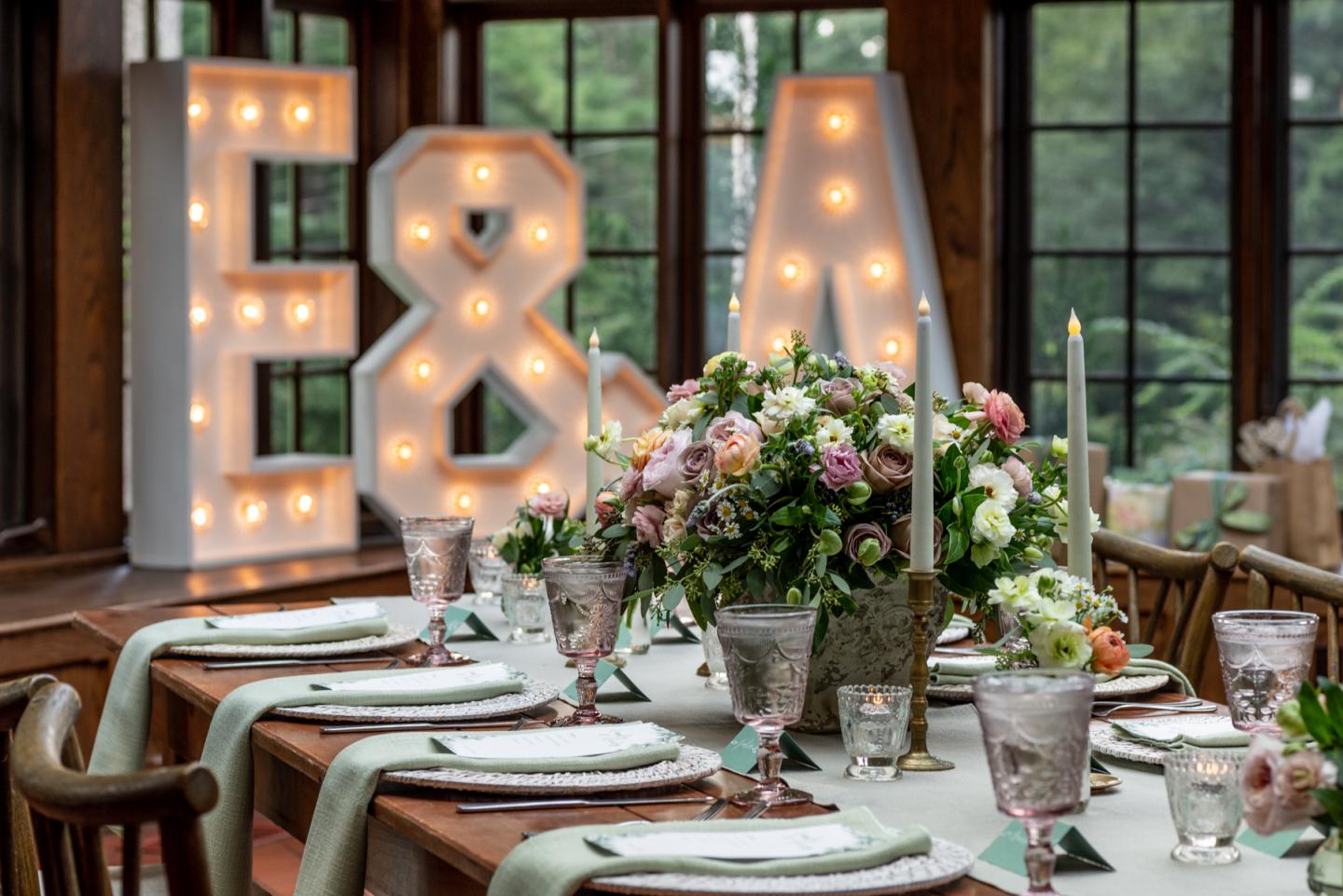 Big illuminated letters E&A site at the head of a table